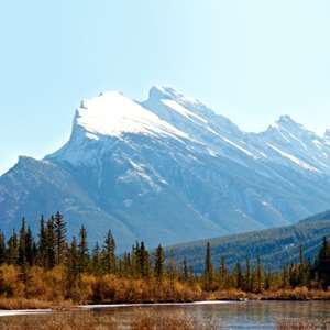 Blue water lakes, forests and snow covered mountains